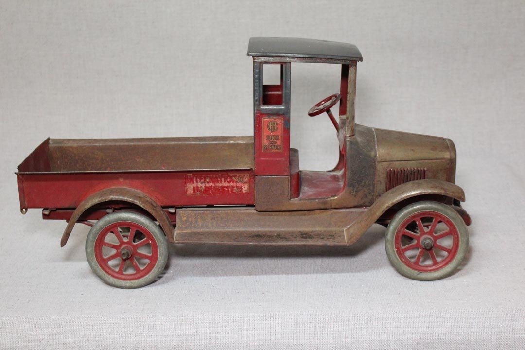 Buddy L Pressed Steel Truck: American Harvester delivery truck with operating tail gate and steering wheel that turns the front wheels. 24" x 9" x 12" high. See photos for condition.