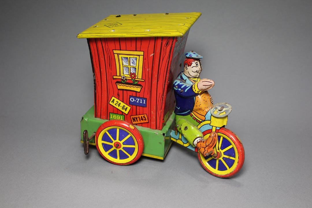 Wyandotte Humphrey Mobile: Wind-up tin lithographed toy with moving legs, an arm that goes up and down and his hat that also goes up and down, copyright Ham Fisher. Wyandotte logo on the roof. Smoke stack missing, rivet on one 