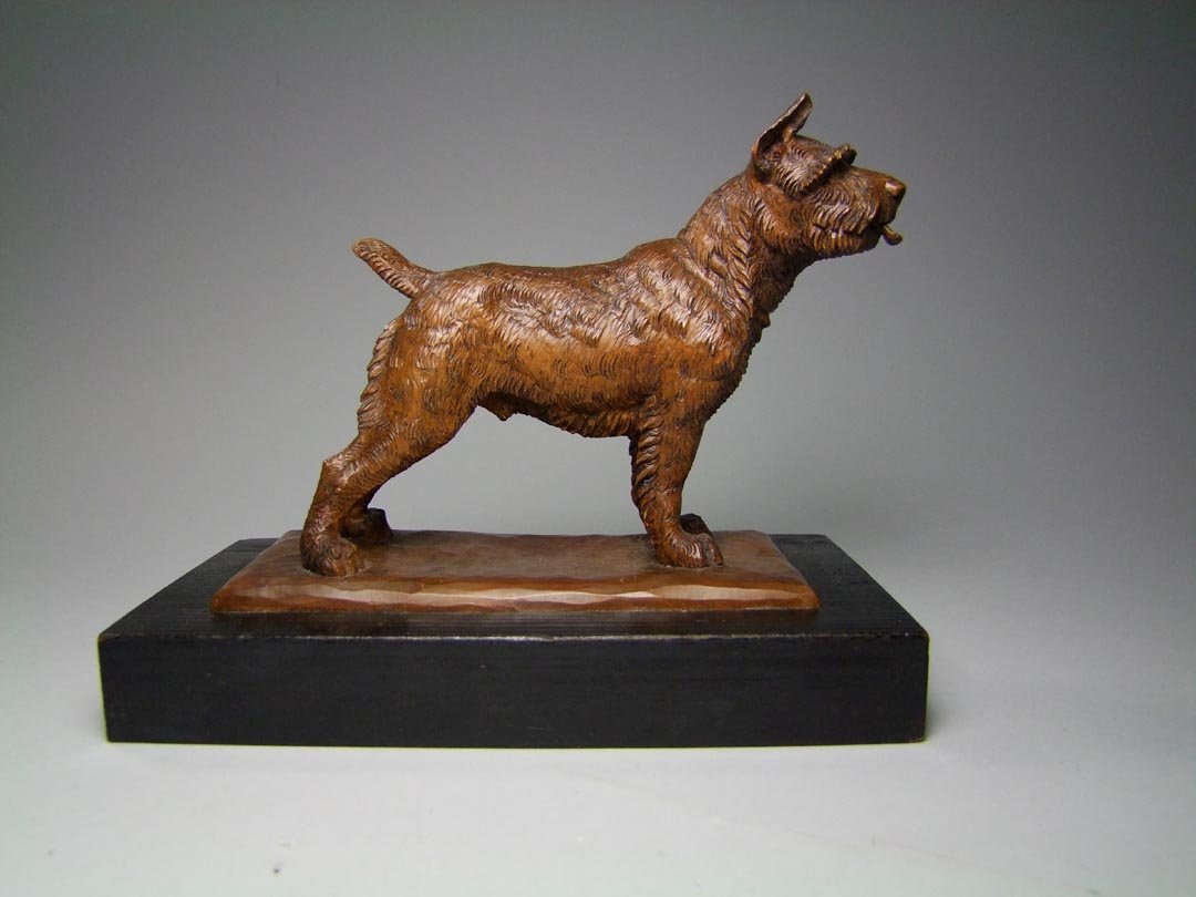 Carved Black Forest Dog: Expertly carved dog standing at attention with glass eyes, signed "Sailer". Set into a painted black base. 8 1/2" x 4 1/2" x 6 3/4" high. Very good condition.