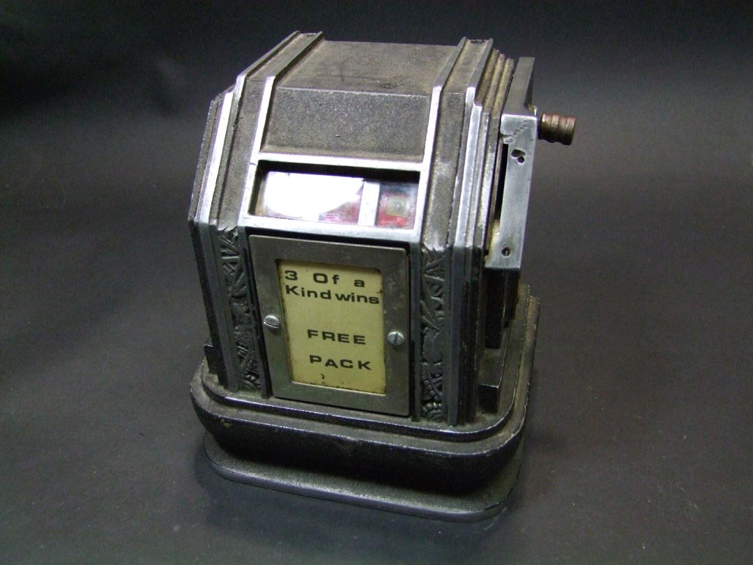 Trade Stimulator: Art Deco 1930s Bally Baby 3-reel 1 cent cigarette trade stimulator. Decorative metal cover for coin drop-slot is missing and missing one screw. Works. 6 1/4" x 5" x 7" high. Key included and how ever