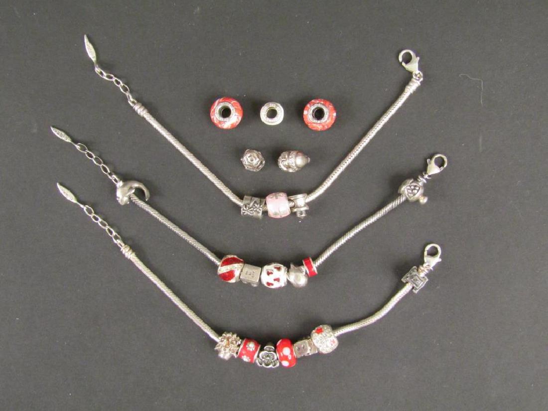 3 Sterling Silver Amore & Baci Charm Bracelets: Charms with sterling silver accents. Extra charms. 3.1 troy oz. (including charms).