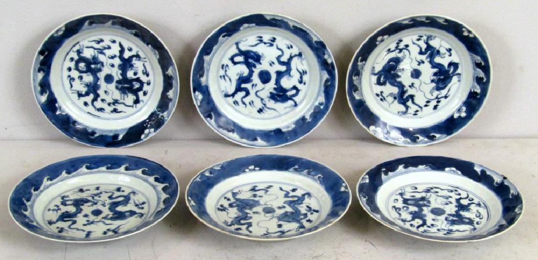 Set of 6 Chinese Blue and White Plates: Double dragon design centers, signed with double ring bottoms. All with rough edges and slight chips on rims. 8.25"0