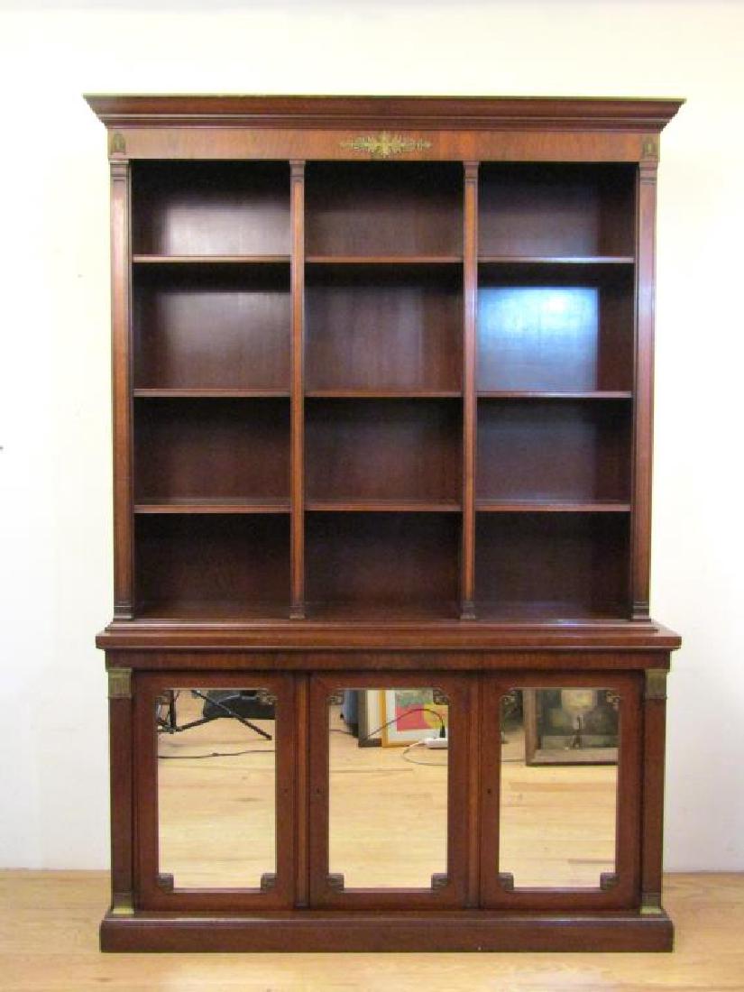 Kittinger Breakfront Bookcase Cabinet: Two part mahogany case with metal mounts. Top with 9 shelves, three mirrored doors with two shelves each. Label on lower bottom of back. 59"W X 16"D X 85.5"H