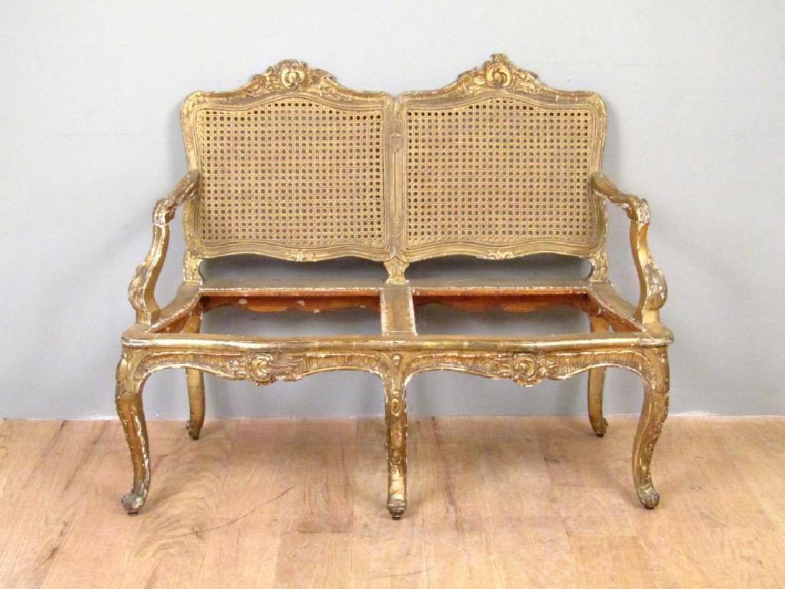 French Caned Loveseat: Carved and gilt frame with caned backs. No cushions. 47"W X 19.5"D X 37.5"H