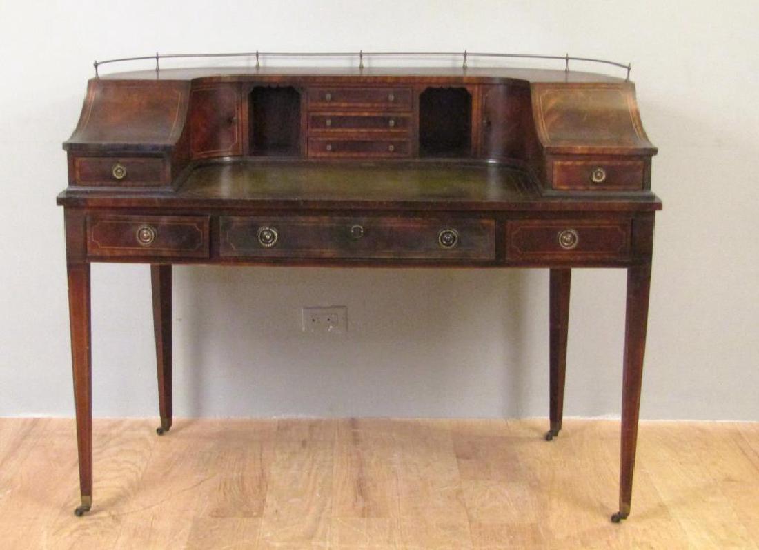 Carlton House Mahogany Desk: Curved superstructure with metal gallery and sloping sides over a tooled leather top. All over inlaid drawers. Finished back. 50"W X 27.5"D X 39.5"H