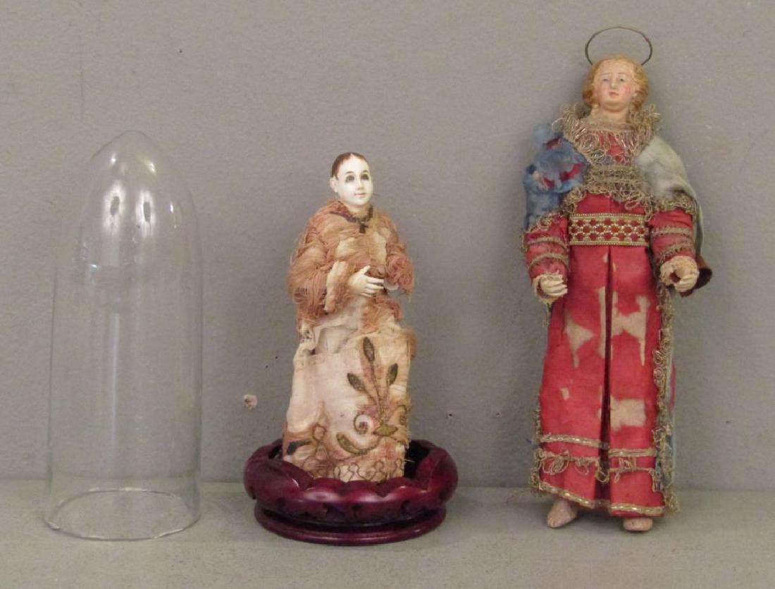 2 Antique Creche Dolls: Carved bone woman with articulated joints, with bell jar. Figure of a saint with painted wood head. 9.5"H