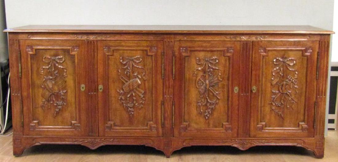 Don Rousseau Sideboard: 4 carved panel doors. Interior shelves and drawers. Fluted and reverse fluted carving on sides. 84.5"W X 20.5"D X 34"H