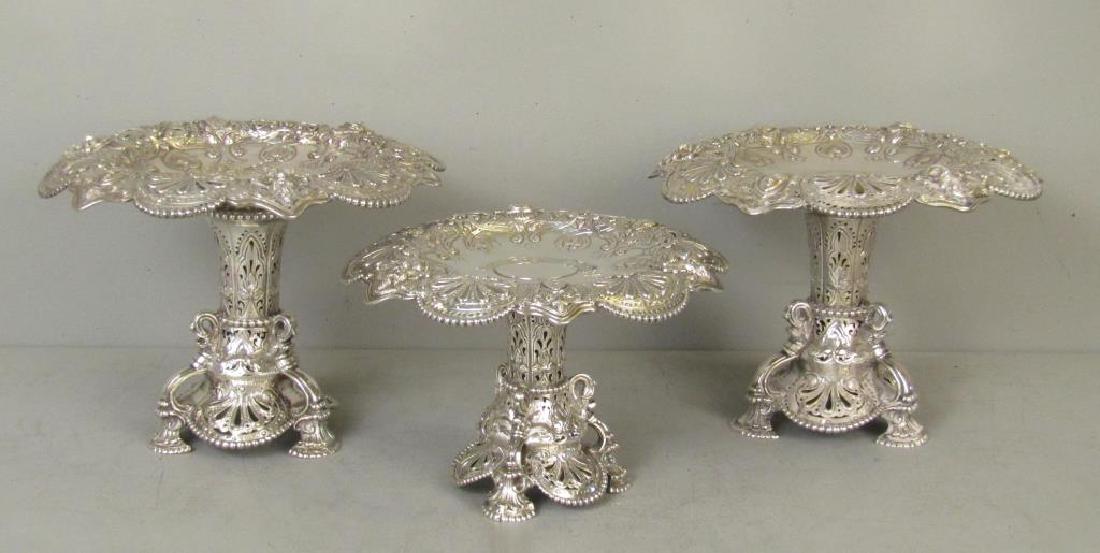 3 Piece English Silver Coupe Garniture: Pierced rims with figural moldings. Pierced bases. Marks on 2 larger ones. 12Dia. X 8.5"H"