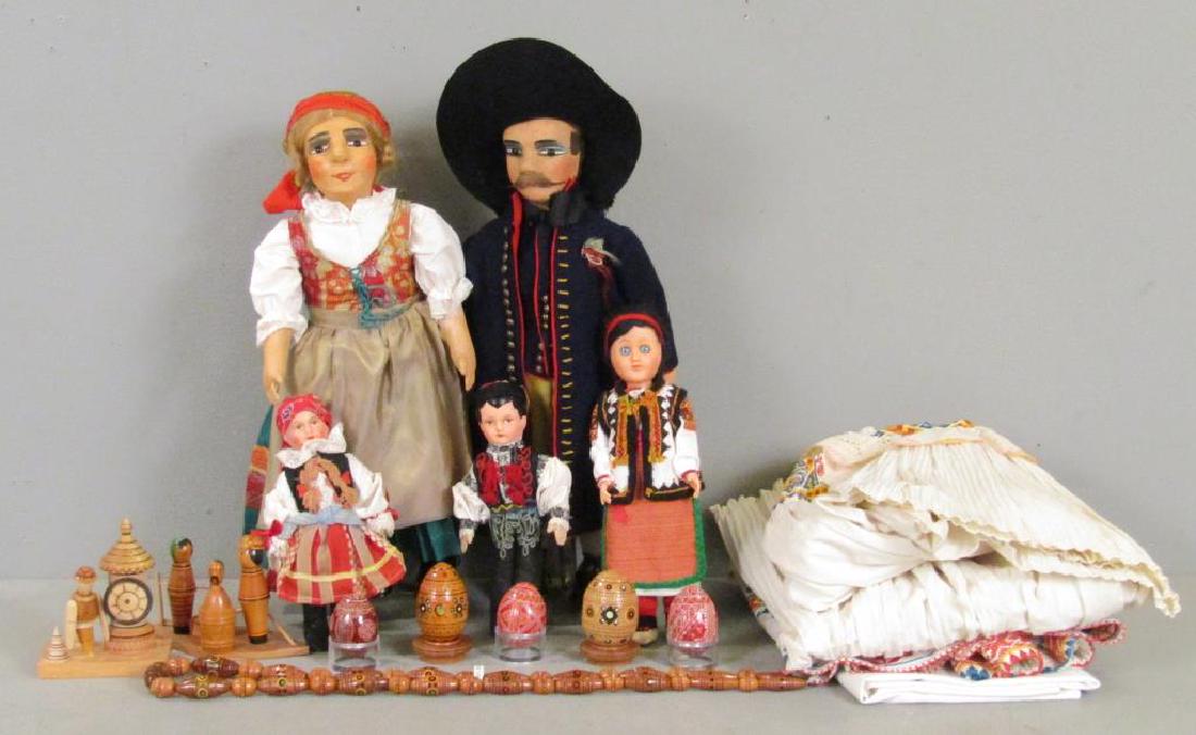 Ukrainian and Czechoslovakian Articles: Set of two carved wood eggs, set of 3 painted eggs, wood toys, and costumed doll. Czechoslovakian costumed figure, traditional woman's costume, and two large dolls (larger: 21"H). (From the Newark Mus