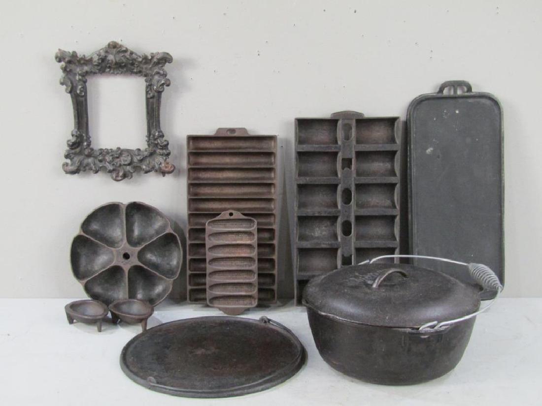 Grouping Cast Iron Cooking Elements: Molds, pot, and a frame. Lodge, Griswold, Wagnerware, etc. (From a West 66th Street Estate)