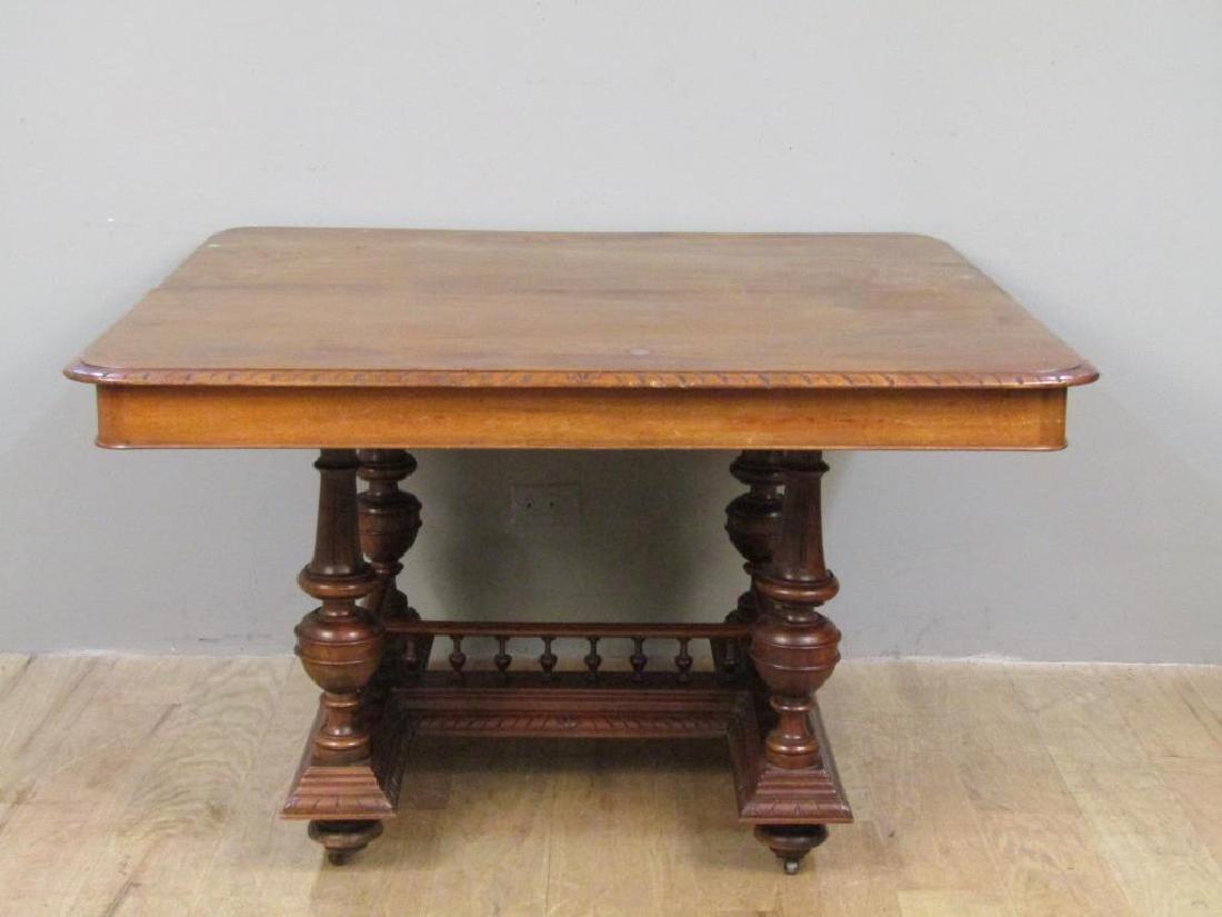 Elizabethan Style Extension Dining Table: Top with carved edges. Base with 4 supports over stretcher with spindle rails. 46"W X 47"D X 30"H (with six 10" leaves) (From a Jericho NY Estate)