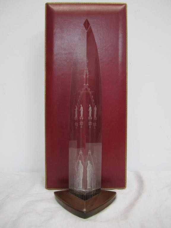 Rare Steuben Presentation Piece "Cathedral": In red leather and red silk lined fitted case. Signed on bottom hidden by fitted walnut stand. Designed by George Thompson for Steuben. "Tall prismatic form of clear crystal, shaped and engraved to su
