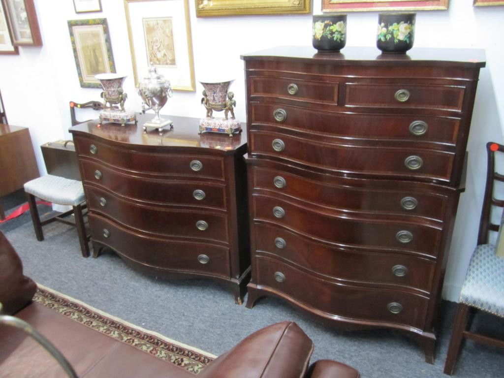 7 Piece Chippendale Style Bedroom Ensemble: Serpentine Chest and dresser, Pair ladderback and scoop seat side chairs, Pair ladderback headboards, and a small mahogany stand.