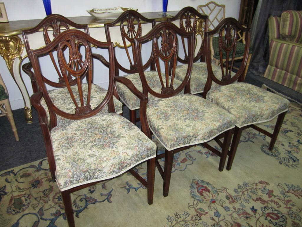 Set of 6 Hepplewhite Style Dining Chairs: Carved shield form mahogany backs. "H" stretcher bases. 2 arm chairs and 4 side chairs.