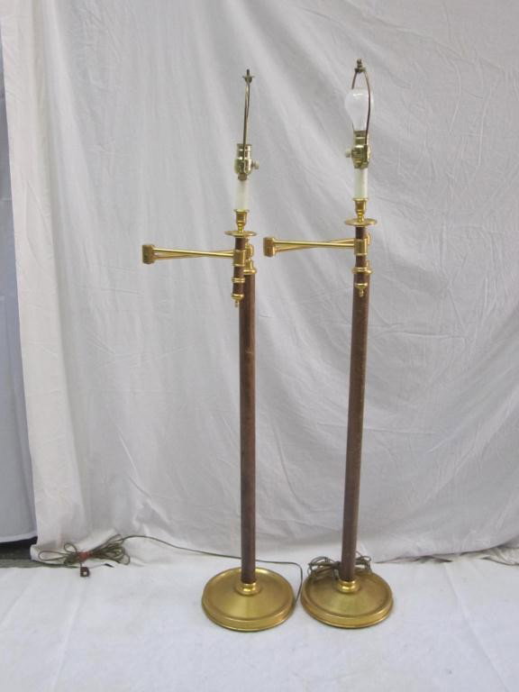 Pair Hansen Style Brass Floor Lamps: swing arms and posts having wood elements and brass mounts. With white plated shades. 53 short extending to 61 tall.