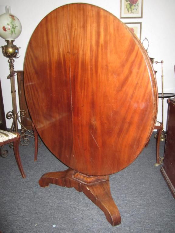 Antique American Breakfast Table: Tilt top mahogany on a tripod pedestal base. 45 dia X 29 tall.