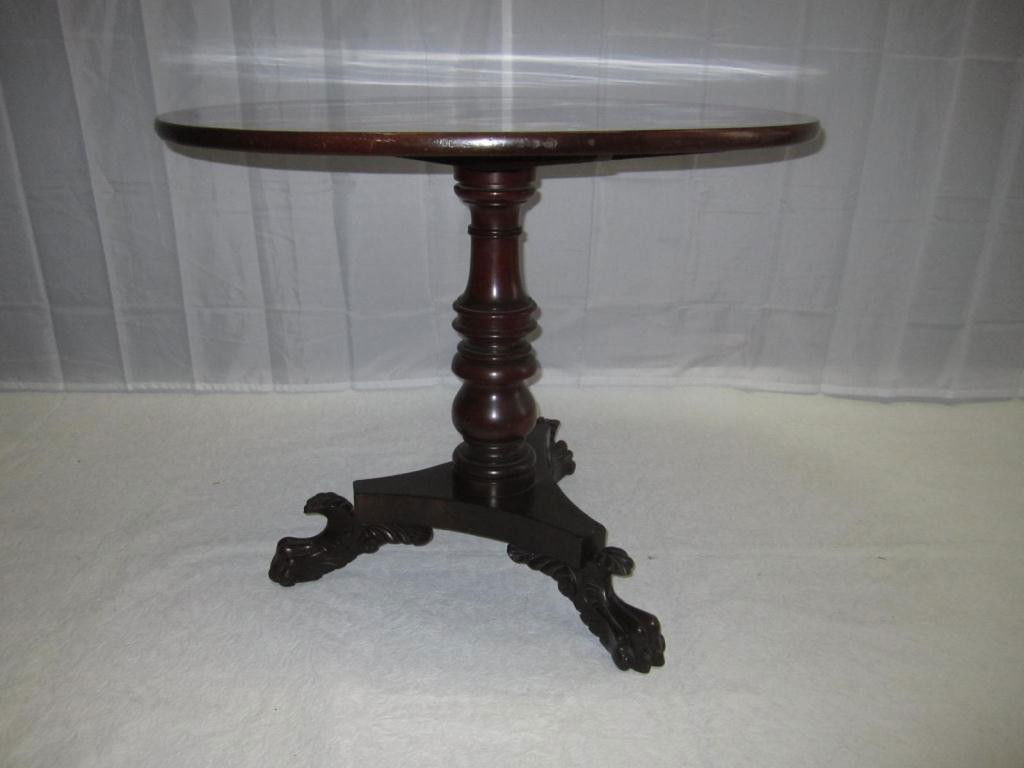 Antique American Tip Top Table: Pedestal post with tripod base ending in Duncan Phyfe style winged and paw carved feet. Mahogany. 32 dia X 26 tall.
