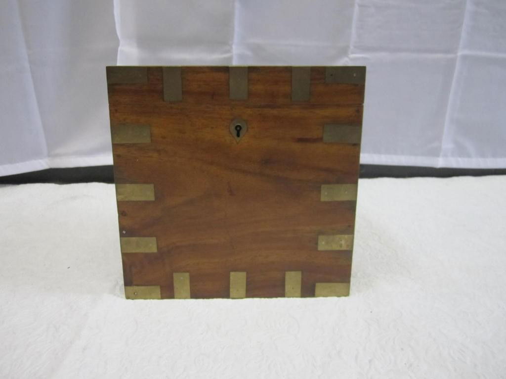 Antique English Campaign Bottle Holder: Brass mounted walnut with 4 sectioned interior. Handle on top having writing etched letters. 8 X 7.5 X 8 tall.