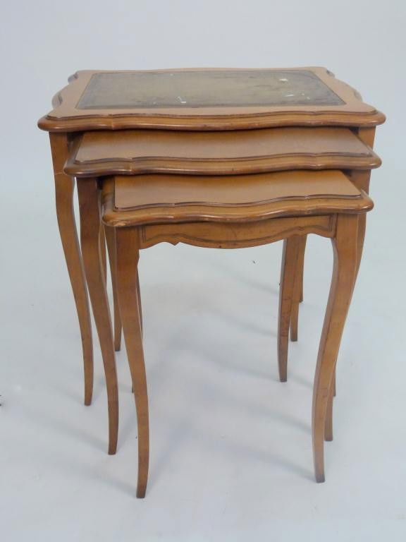 Nest of 3 French Provincial Style Tables: Top one having leather top, serpentine tops. 23 X 17 X 24 tall. 8 East 83rd Street Estate
