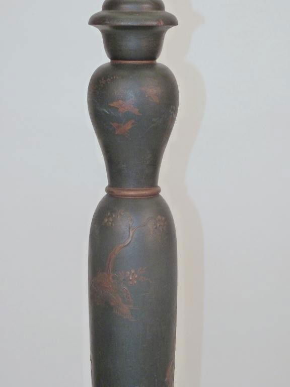 Chinoiserie Decorated Stick Lamp Table: glass table top with gilt hand painted decor. 18 dia X 53 tall.