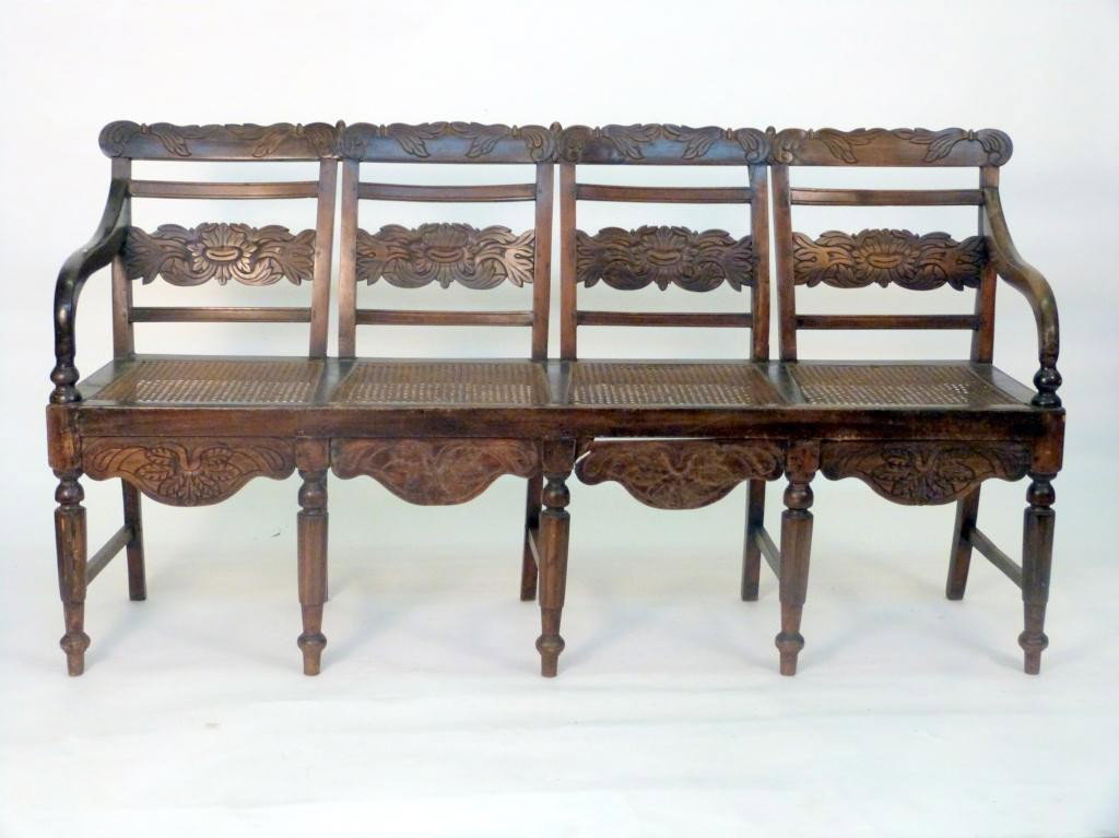 Anglo-Indian Style Long Window Bench: 4 chair back carved and caned seats. 21D X 62W X 34 tall. Estate of Stephanie Queller