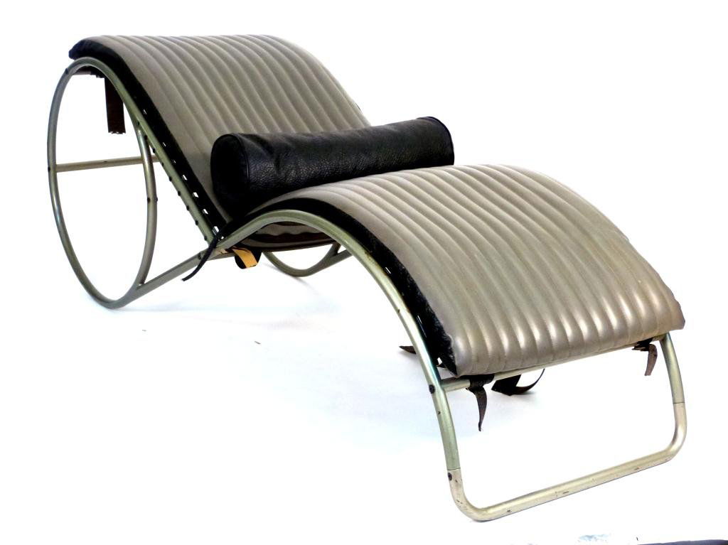Mid-Century Enameled Chrome Chaise Lounge: Circular enameled chrome frame back sloping to a foot rest base. One bolster in leatherette material, on a reversible one piece cushion. Some straps need restoration.
