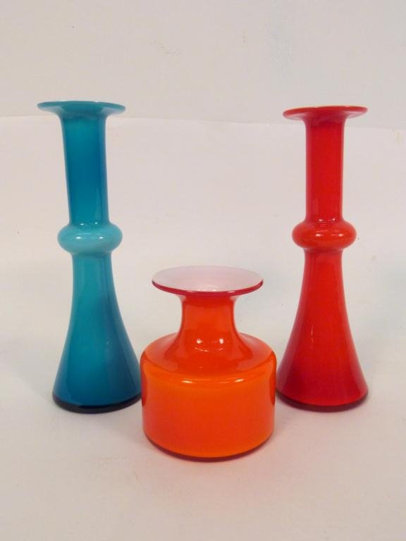 Lot of 3 Danish Art Glass Pieces: Including Pair of Danish Art Glass Candlesticks with an identifying sticker ** (8 1/2H) and an Orange small Vase (4"H) - ** "Kactrup Holmegaard - By Appointment to H.M. The King of Denmark" Made in De