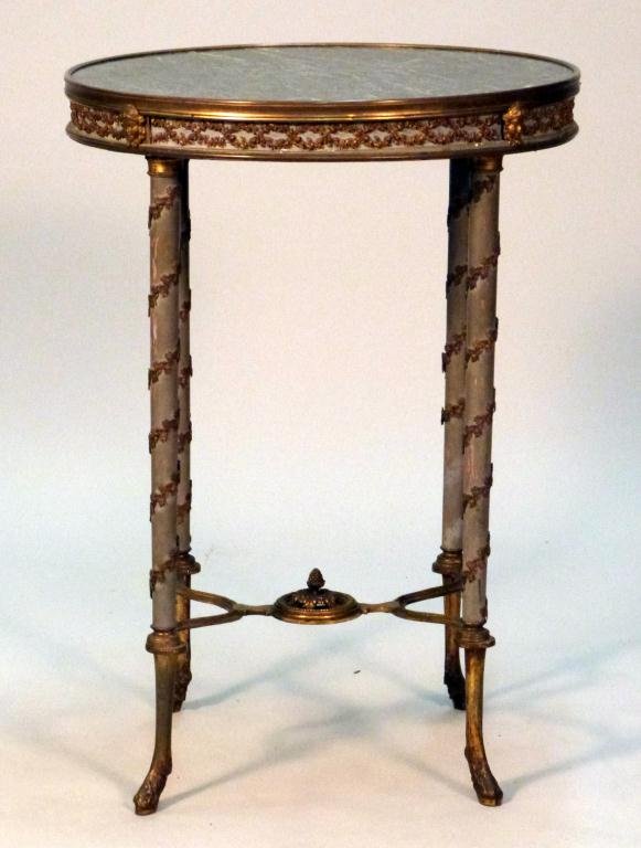 19th Century French Empire Gueridon: Mixed metal frame and mounts, X" stretcher, with an inset marble top. Slight losses to bronze twist. 20 1/2"D x 28 1/2"H"