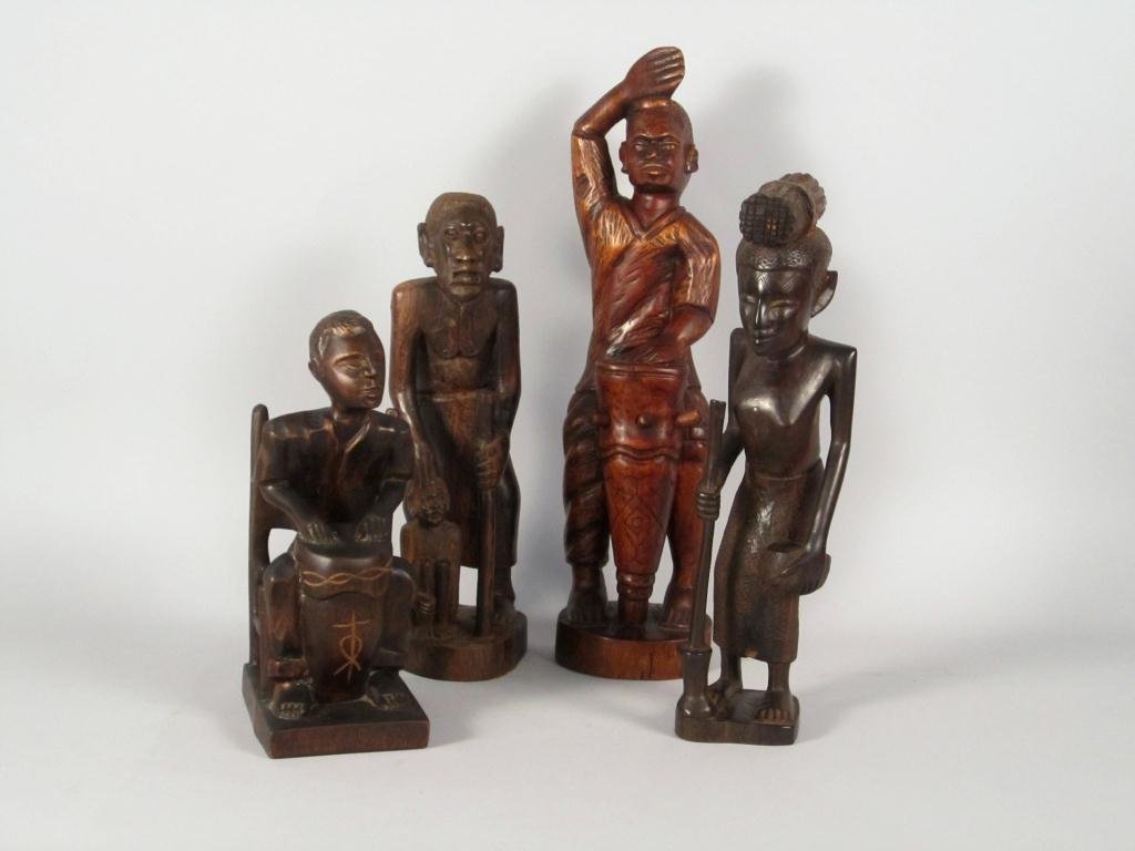 Four Ethnic Carved Wood Figures: Man in chair, signed Simeon: 12H, Man with Boy: 15 1/2"H, Man with Drum - Haitian: 20"H, Woman with Staff - Kenyan: 16"H."