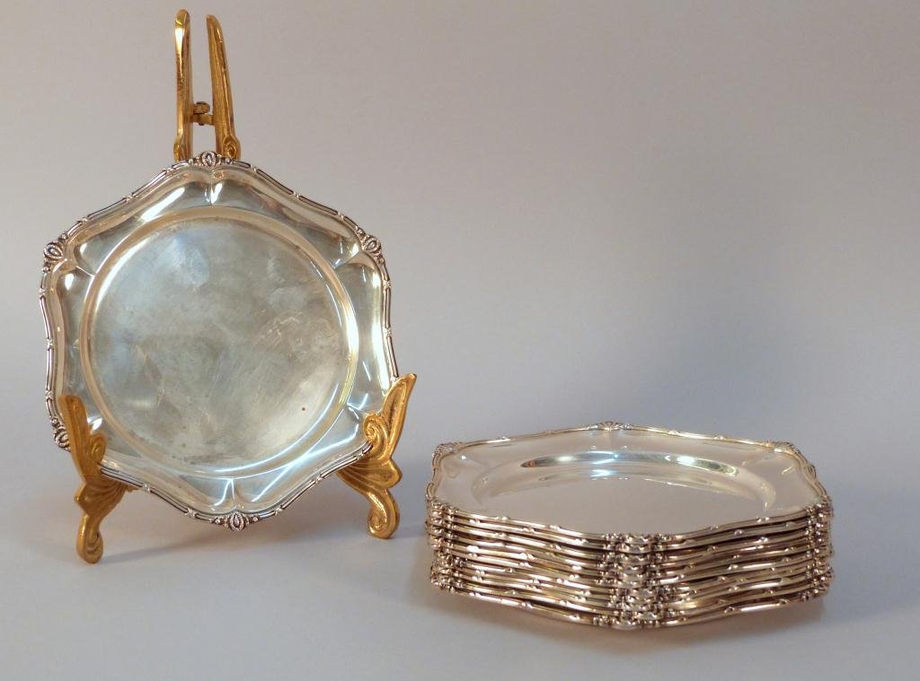Set of 12 Sterling Bread and Butter Plates: Adams Style Rim. 7Dia. 56.42 troy oz. Mauser & Co. Circa 1900."