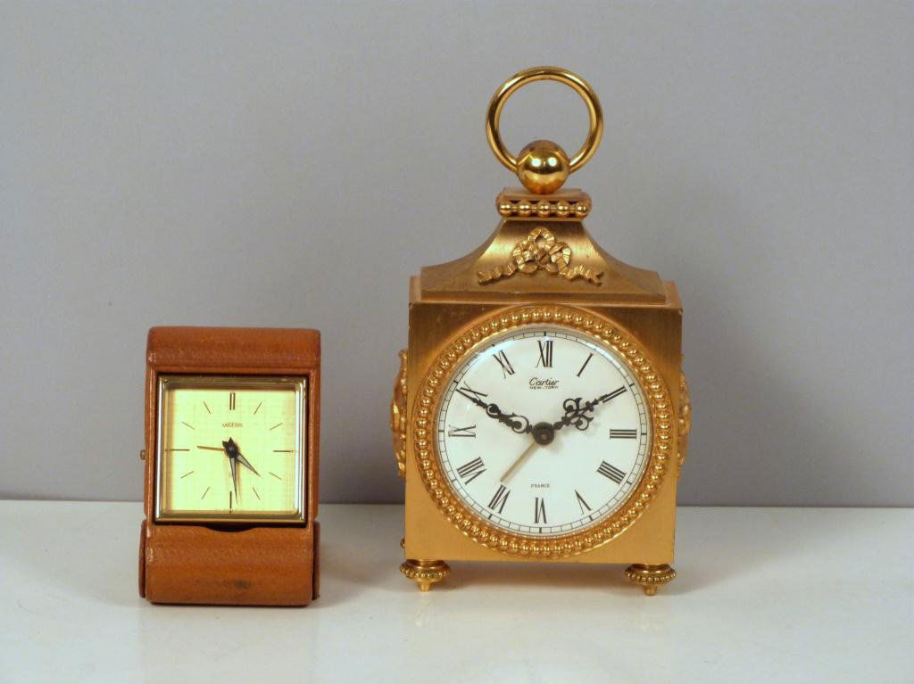 Two Brass Table Clocks: Angelus Travel Clock in Leather Case, and Cartier French.