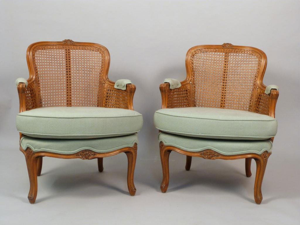 Pair French Bergeres: Double caned sides, carved fruitwood. Upholstered and pad seats. 24W X 22"D X 31"H"