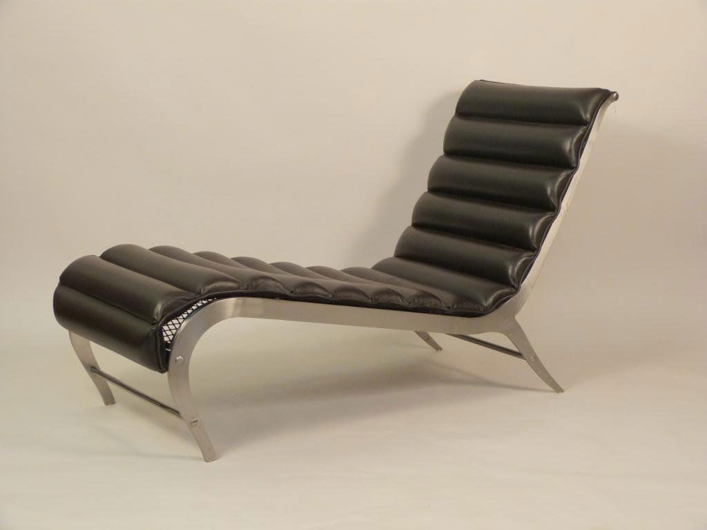 Mid Century Style Chaise: Mies Van Der Roh style, polished aluminum, black channeled vinyl on mesh frame. 23 W X 60" D X 34" H. From a Hackensack, NJ Home."