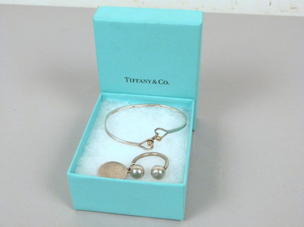 Two Tiffany & Co. Sterling Articles: Small bracelet with 18 KT gold balls, and sterling baby charm with box