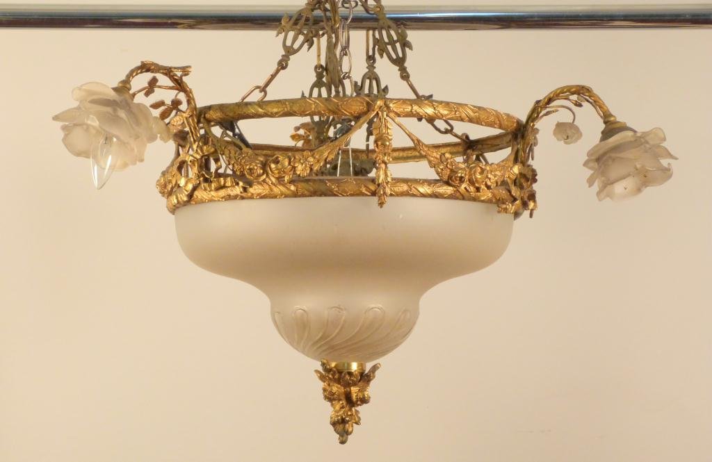 Louis XVI Style French Gilt Metal Chandelier: Valence design. Frosted floral shades. Large frosted and clear swirl dome. Ring 17D. Arms 7". 15"H. 20" Chain. * One frosted shade as is"
