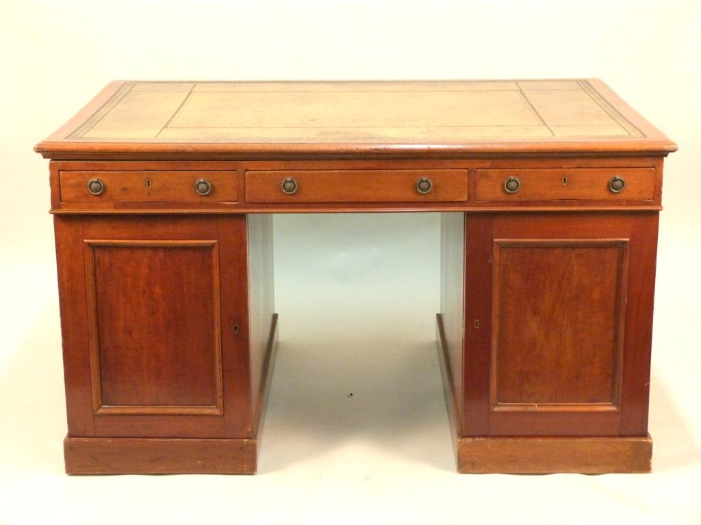 Antique English Partners Kneehole Desk: tooled leather top. Each center drawer having leather lift top. Ring handles. Pedestal bases with doors and interior graduated drawers. Some veneer losses. 56 W X 38" D X 32" H. (Estate of Peter Jenni