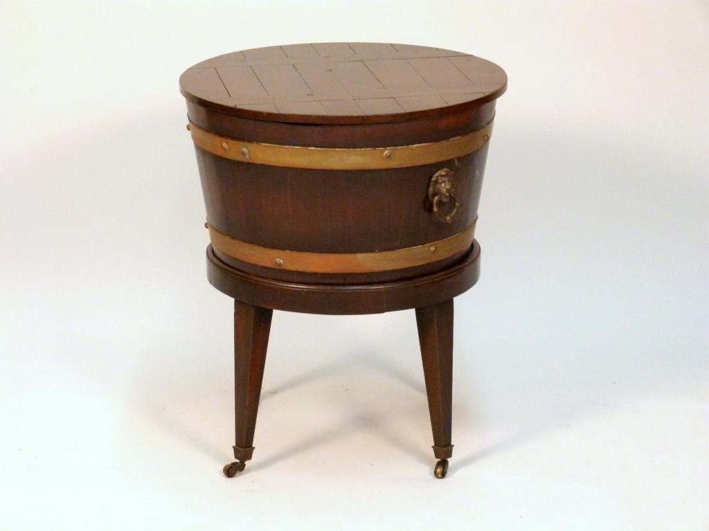 English Mahogany Round Cellarette: Rusted liner. Brass ring handles, on casters. 20 Dia. X 24" H. (Estate of Dr. David Becker)