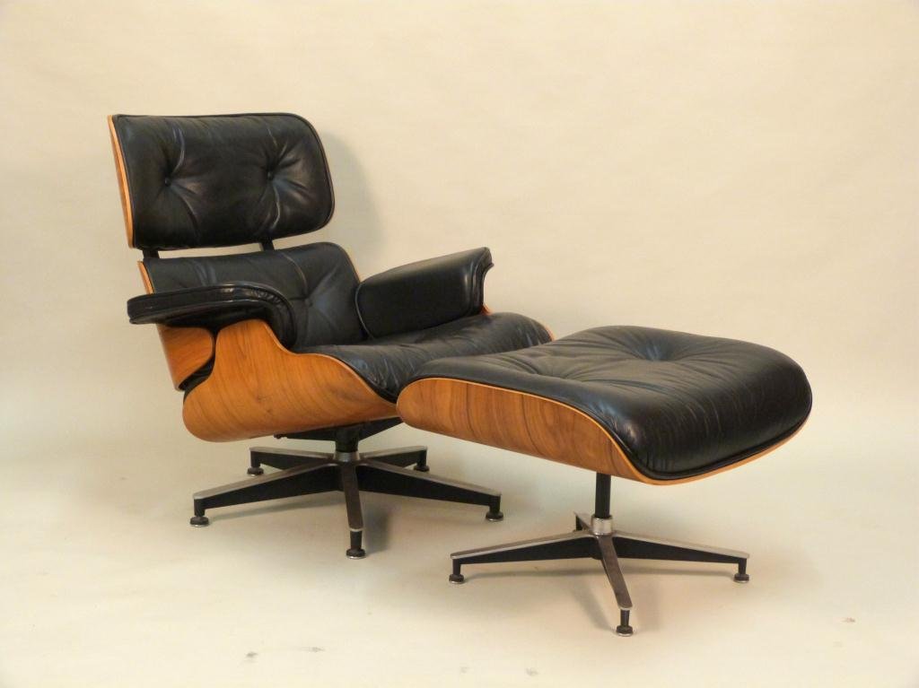 Classic Knoll Eames Chair and Ottoman: Black button tufted leather on Plywood. Circa 1970's. Missing labels. Buttons on chair seat missing. (A Riverdale Collector) Chair 32 1/2 W X 31" D X 32" H, ottoman 25 1/2" W X 21" D X 16" H"