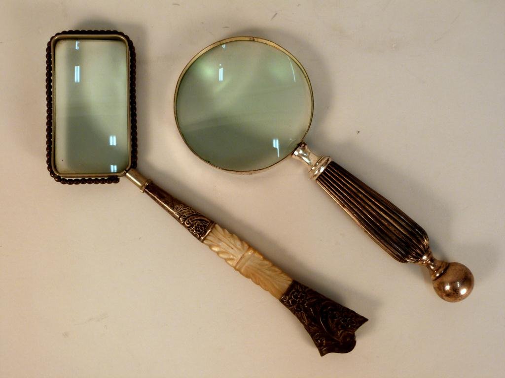 2 Magnifying Glasses: One with Sterling and mother of pearl handle, one plated and chromed with a chip in glass.