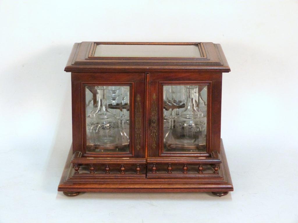 Antique English Tantalus Set: Mahogany case with beveled glass. 4 Matching bottles with star etched stopper tops. Aperitif glasses not matching, 1 missing. Swing doors with gallery fronts. 16W X 14"D X 12"T"