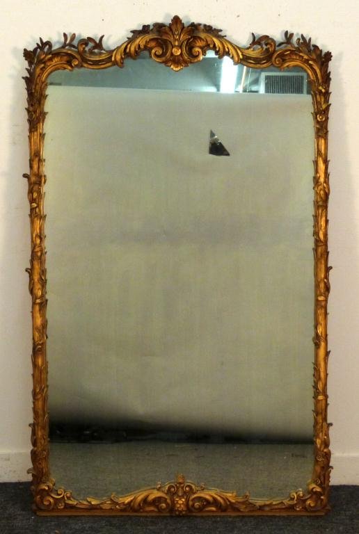 French Gilt Gesso Pier Mirror: Scrolling vine sides and pediment, some losses, 58 H x 35" W."