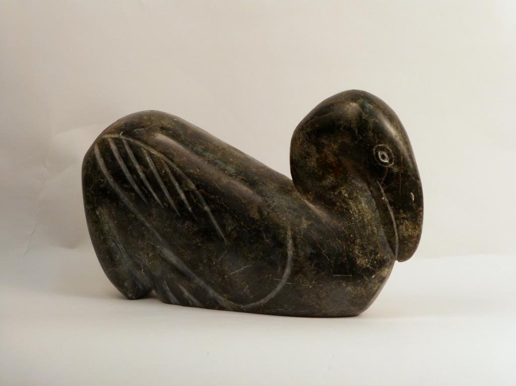 Inuit Soapstone Carving: Green stone, depicting a bird, 11 1/4 W x 7" H."