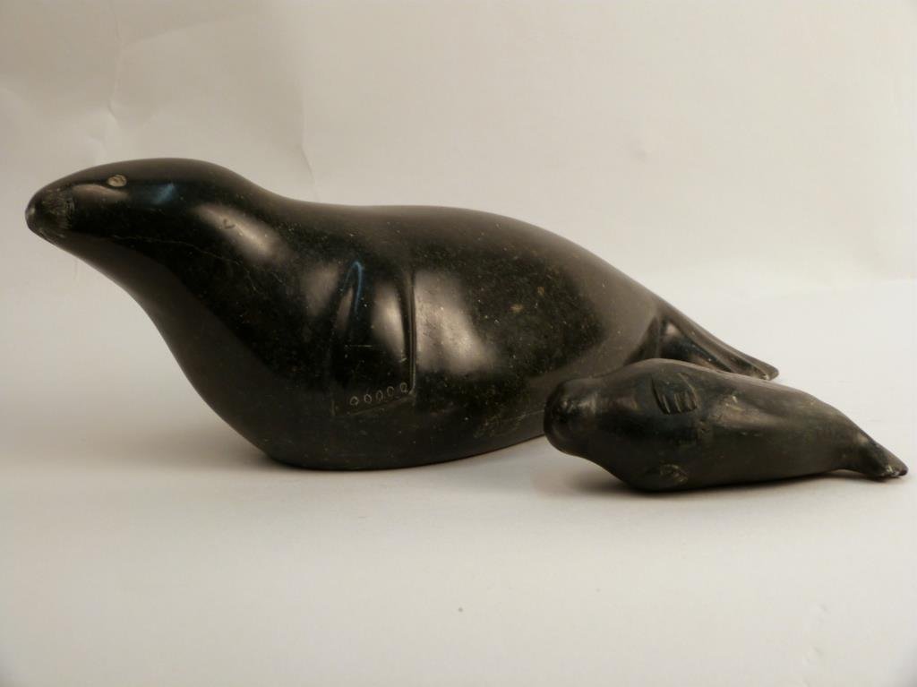 Two Inuit Soapstone Carvings: Depicting seals, larger: 11 W x 3 3/4" H, 4 1/4" W x 1 1/4" H."