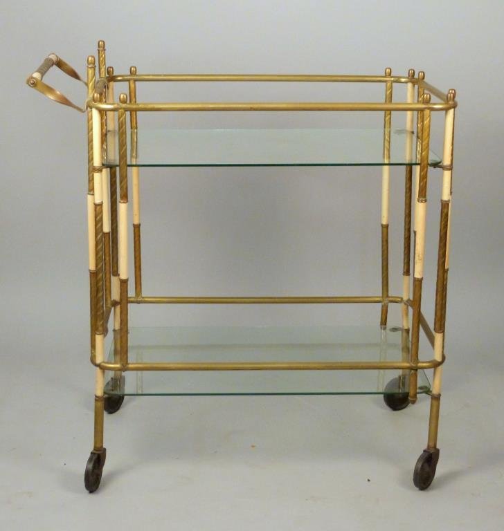 Brass and Enameled Metal Tea Cart: Spiral designed and banded posts, two glass shelves, on casters, 33 1/4 L x 17 3/4" W x 34 1/2" H."