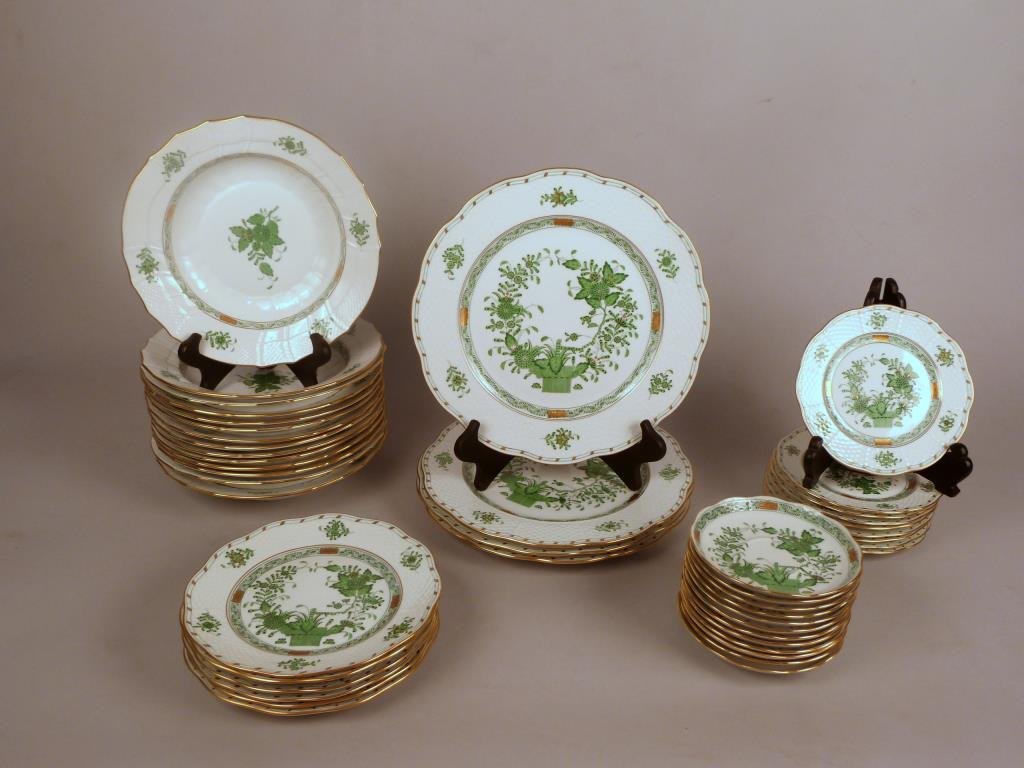 34 Piece + Herend Partial Dinner Service: Porcelain with green and gold floral decoration, 14 bowls, six salad plates, four dinner plates, nine bread plates (chip to one), 12 saucers.