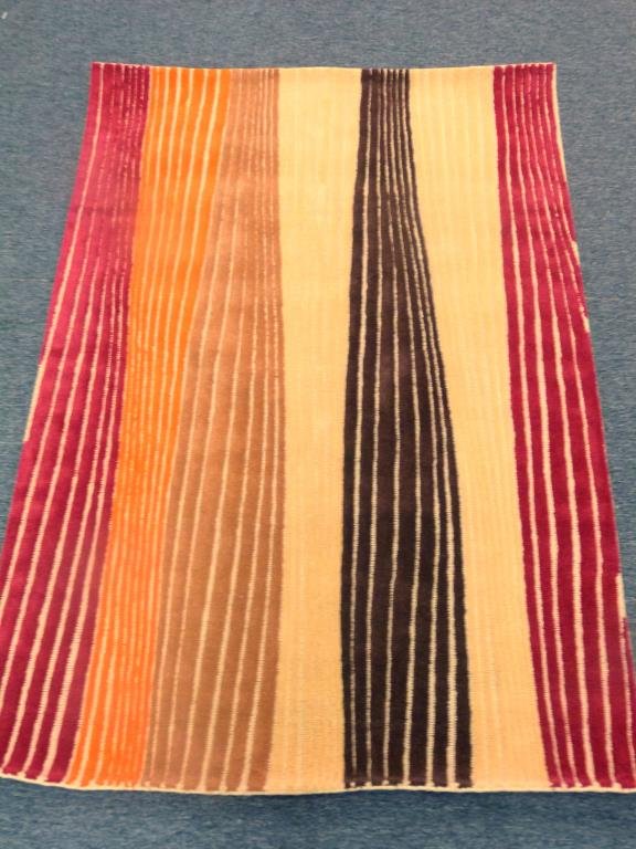 David Shaw Nicholls Pile Rug 5' x 7'6": Riley Rhythm Saffron' pattern. Red, orange, brown, cream. Hand tufted.