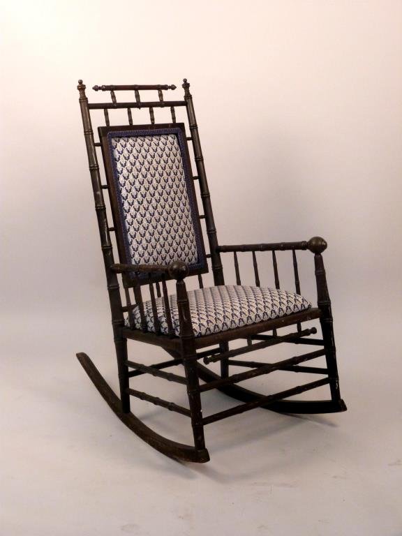 English Faux Bamboo Rocker: Early 20th century. Upholstered back and seat. 23" W x 34" D x41" H.
