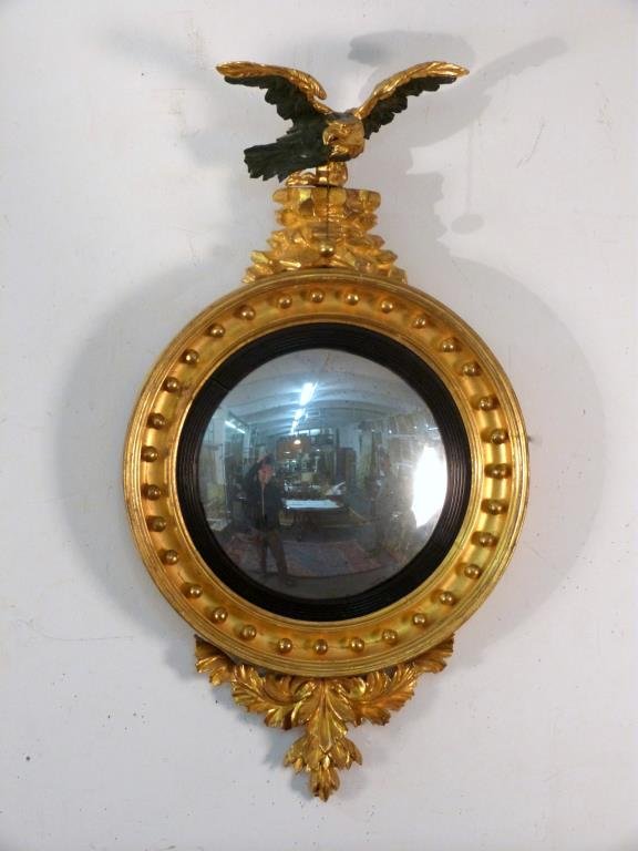 Antique American Federal Convex Mirror: Gilt carved on rock surmount, ebonized reeded inner frame, repairs, 32" T x18" W.