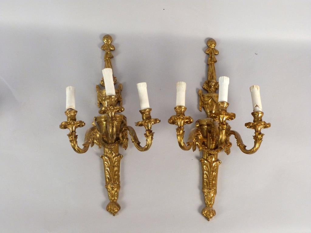 Pair French Louis XVI Style Gilt Metal Sconces: Tassel, swag, and frond decoration, 11" W x 8" D x 22" H.