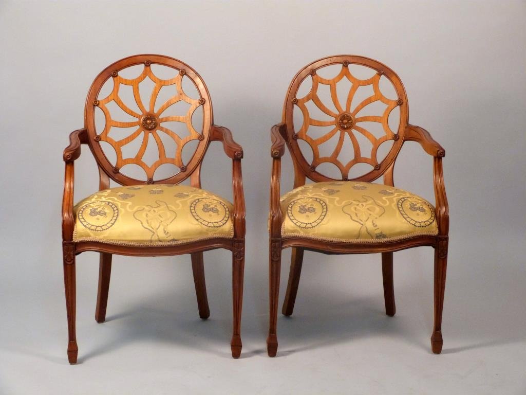Pair of Hepplewhite Style Arm Chairs: Carved frames, upholstered seats. 23" W X 1 1/2" D X 37" H. Upholstery in good condition.
